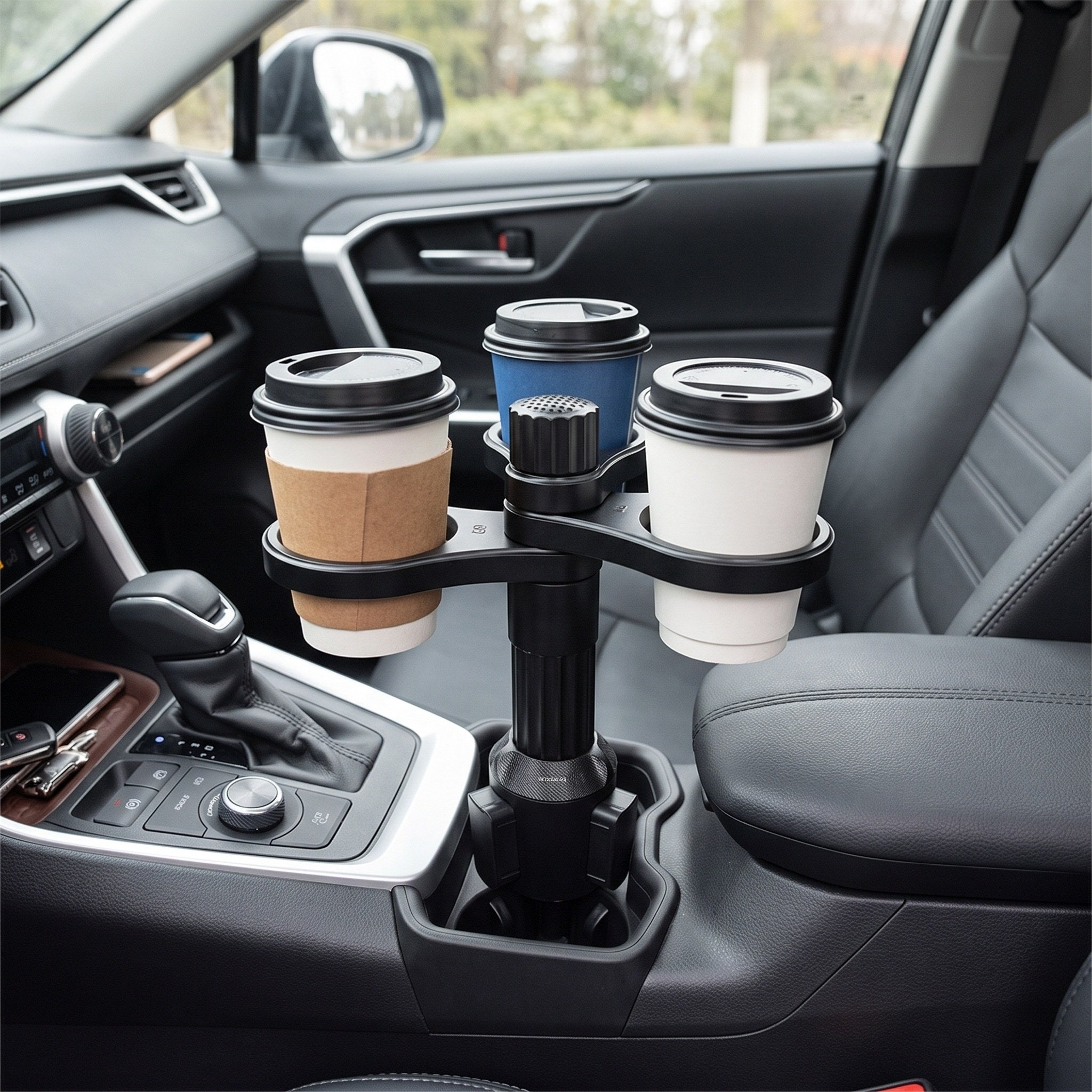 Three lidded cups in the black Ride Along holder in a parked car
