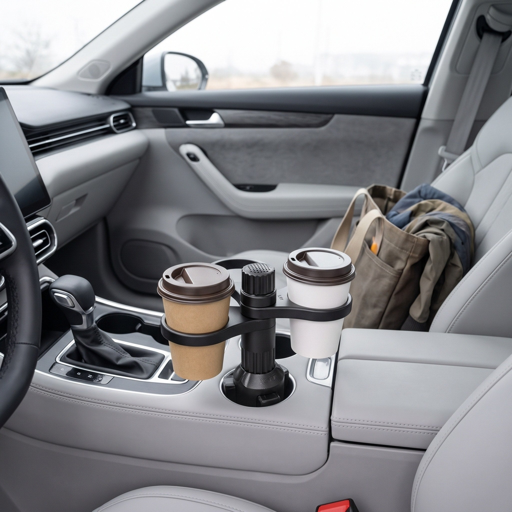 Two coffees and one empty ring in a parked car before a commute