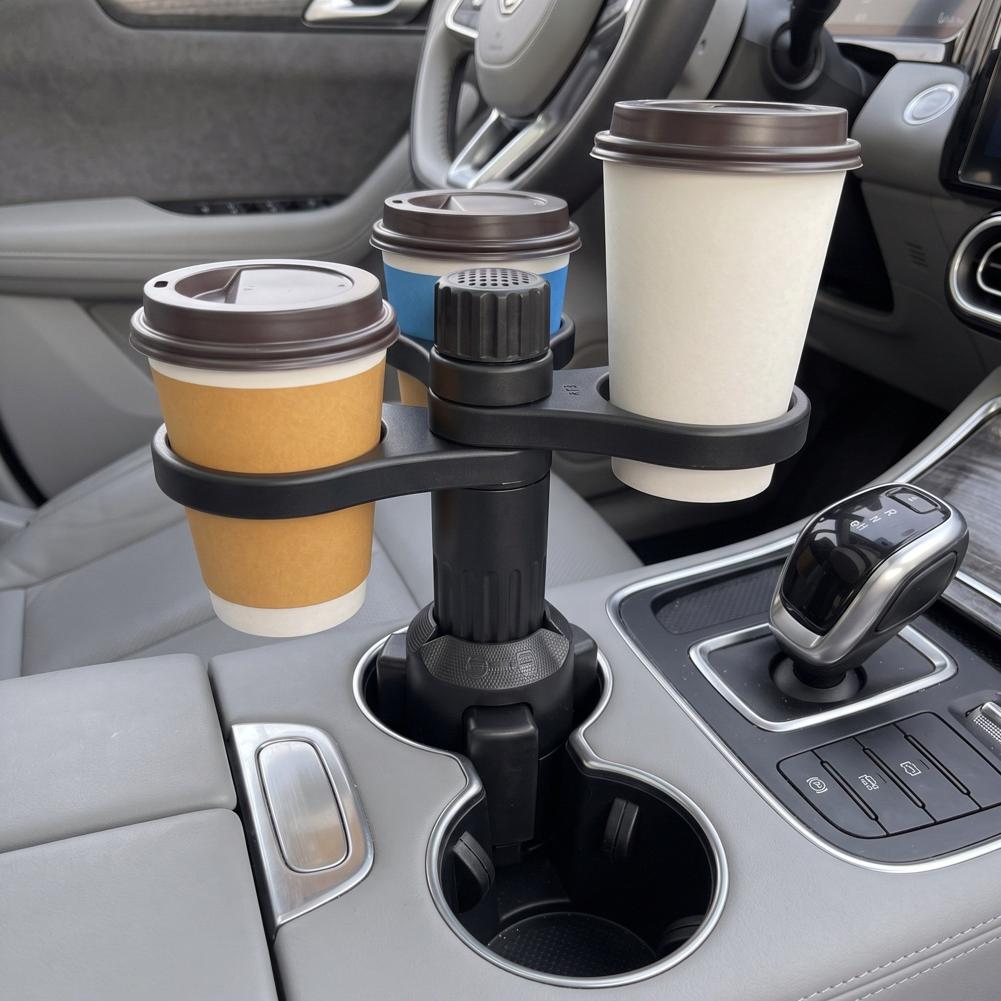 Expanding base seated in an open round holder with gear lever clearance