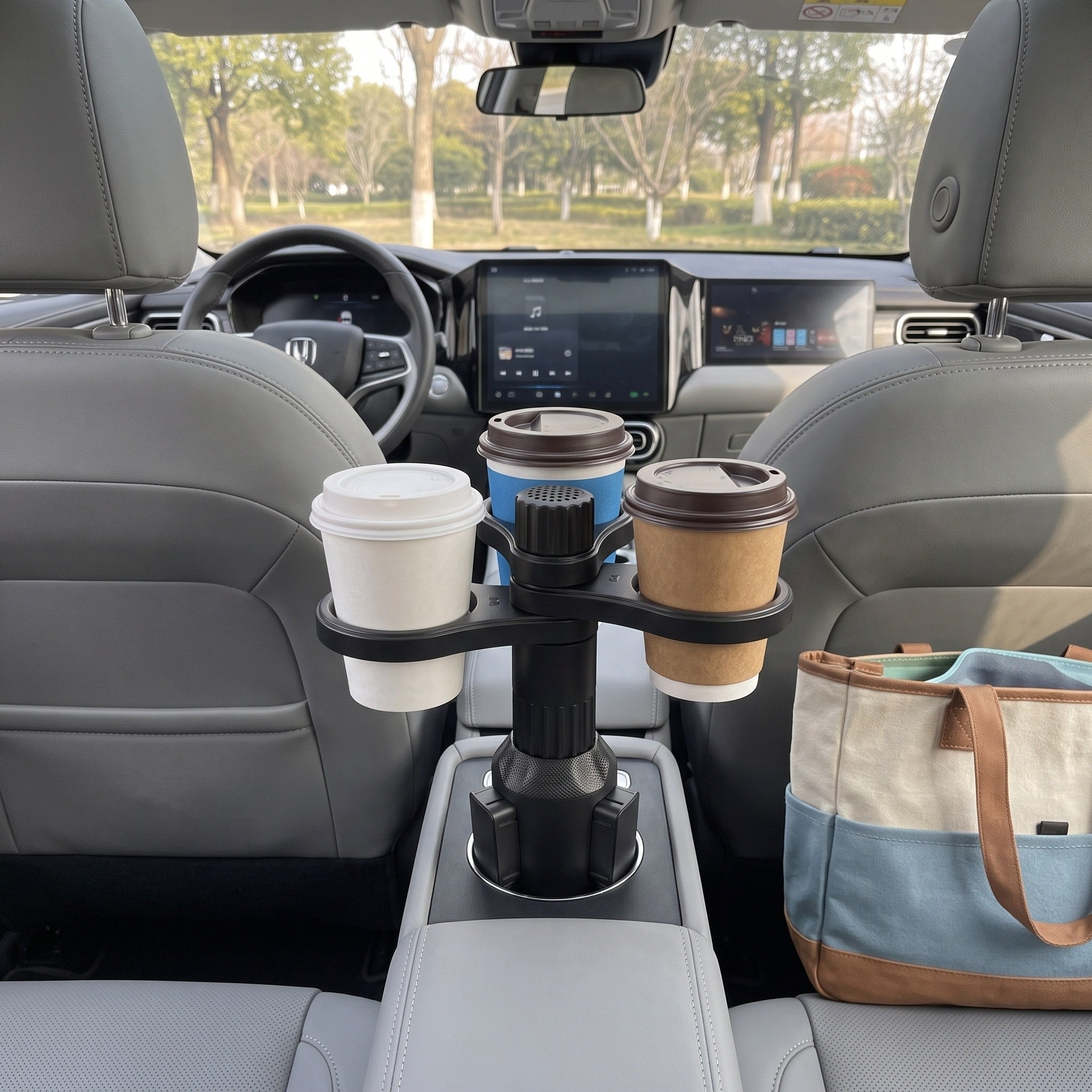 Three cups viewed from the rear passenger seat of a parked family car