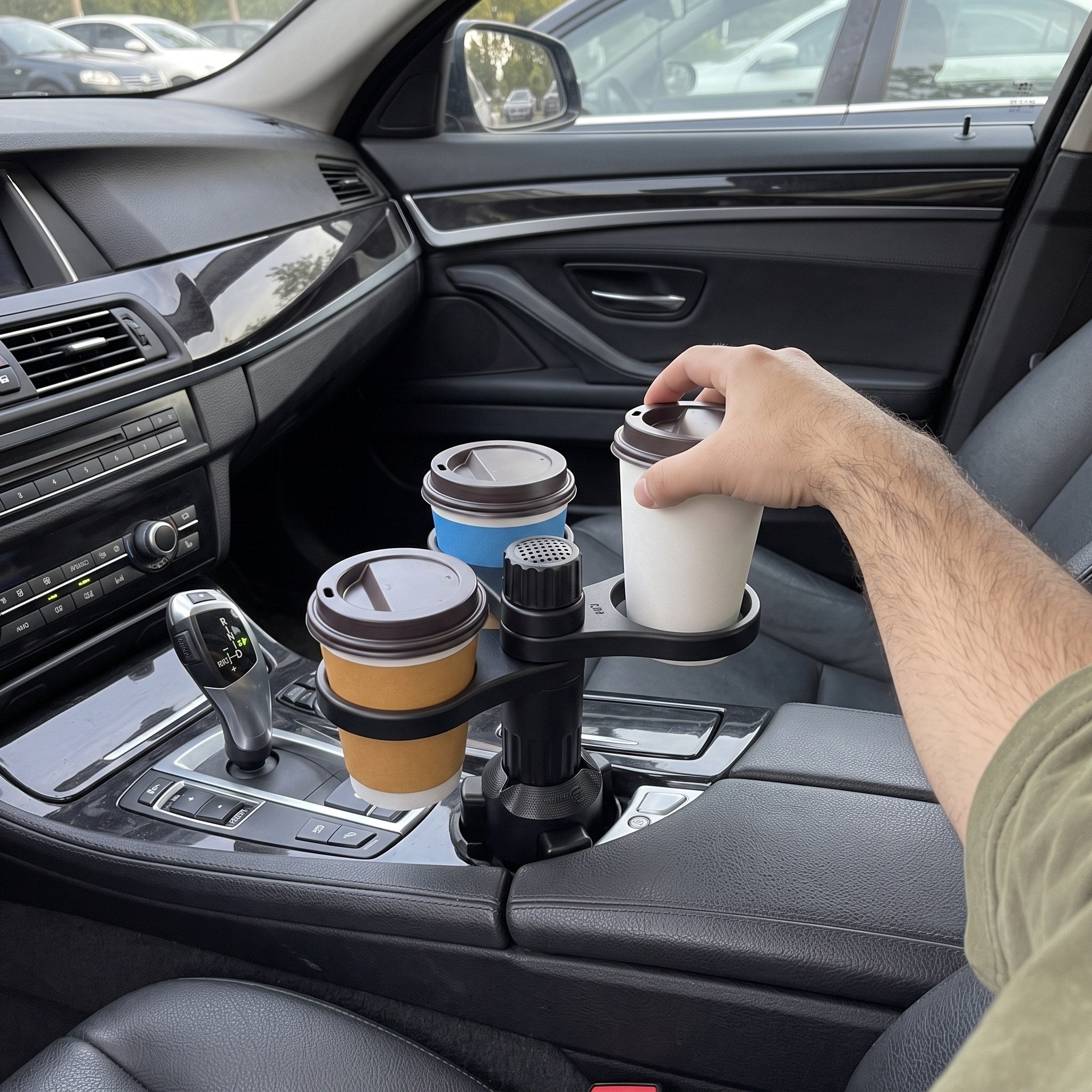 Daniel’s rear-camera view of a hand placing a cup beside two cups